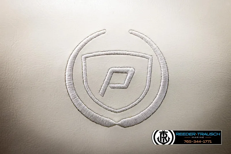 Slide: The Image of 2022 Premier 230 Solaris RL logo on beige upholstery, Reeder-Trausch Marine branding. - 41