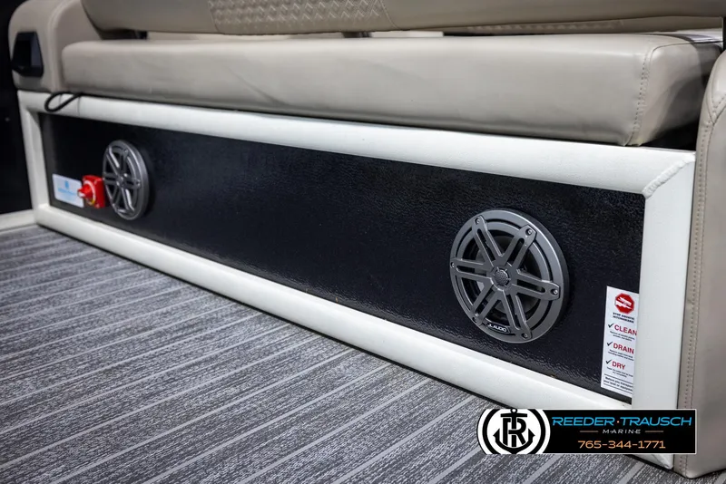 Slide: The Image of 2022 Premier 230 Solaris RL boat interior with speakers and seating on striped flooring. - 47