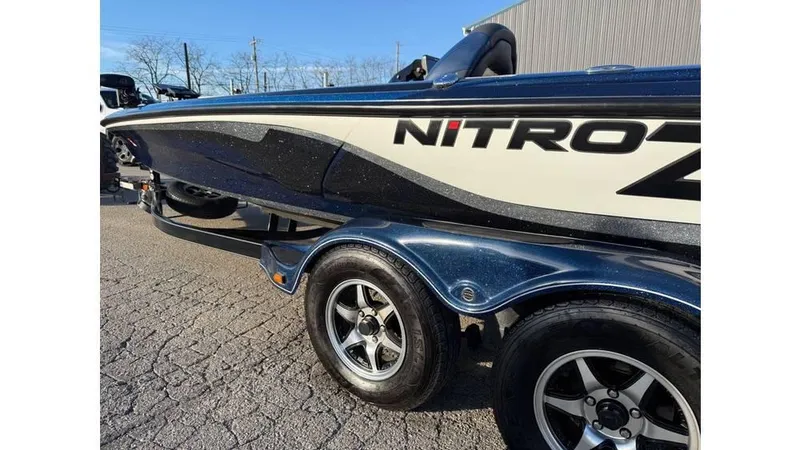 Slide: The Image of 2014 Nitro Z-8 boat on trailer, side view with sleek design and dual wheels. - 10