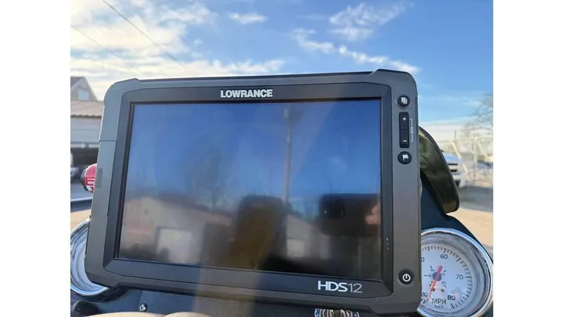Slide: The Image of Lowrance HDS12 fishfinder on 2014 Nitro Z-8 boat dashboard under clear sky. - 2