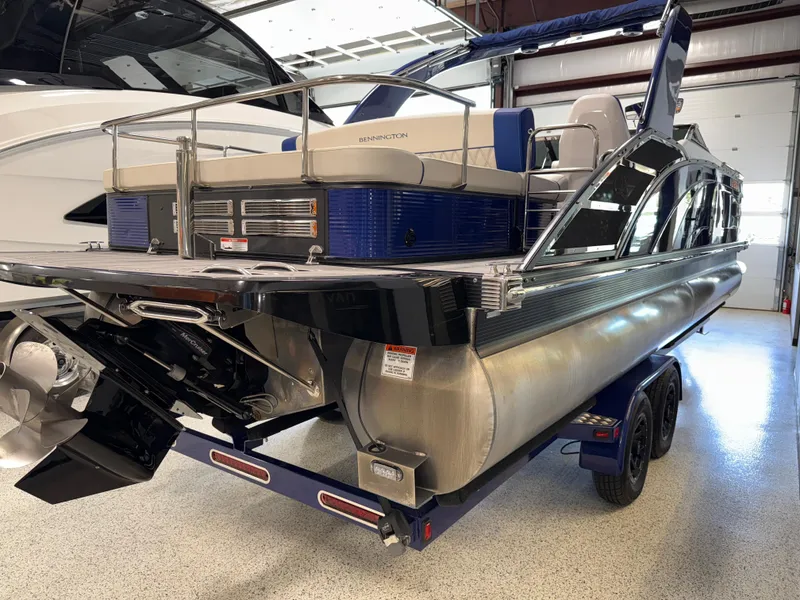 Slide: The Image of 2021 Bennington QX25 pontoon boat on trailer in indoor storage facility. - 10