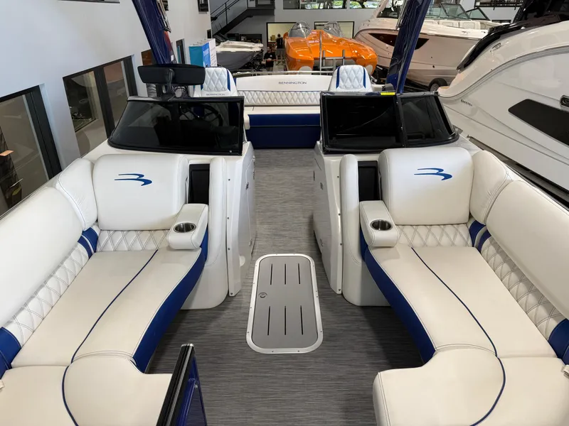 Slide: The Image of 2021 Bennington QX25 boat interior with white and blue seating, modern design. - 19