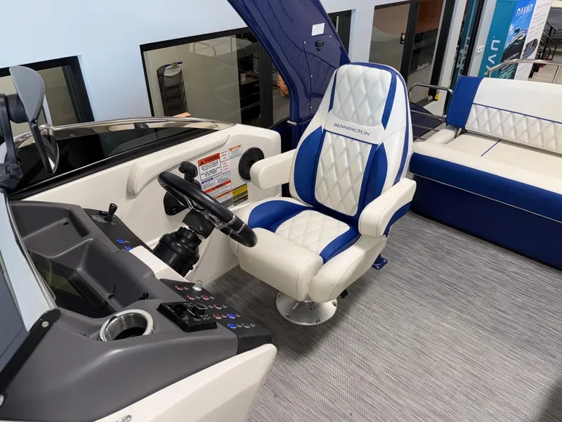 Slide: The Image of Captain's seat of 2021 Bennington QX25 boat with blue and white upholstery. - 22