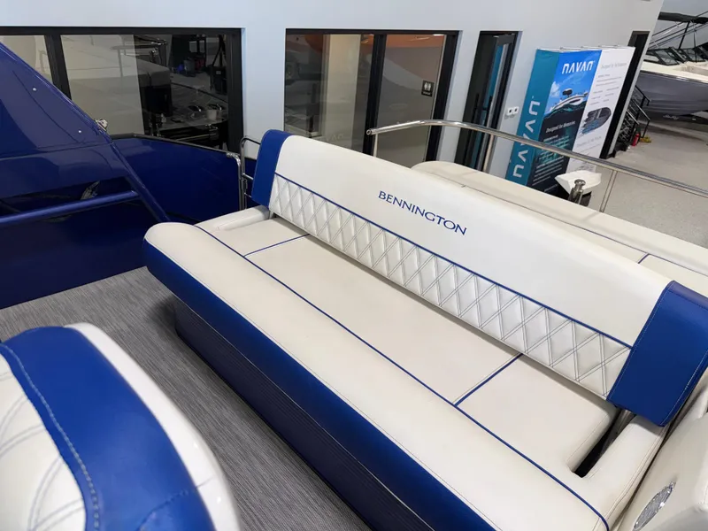 Slide: The Image of 2021 Bennington QX25 boat interior with blue and white seating. - 25