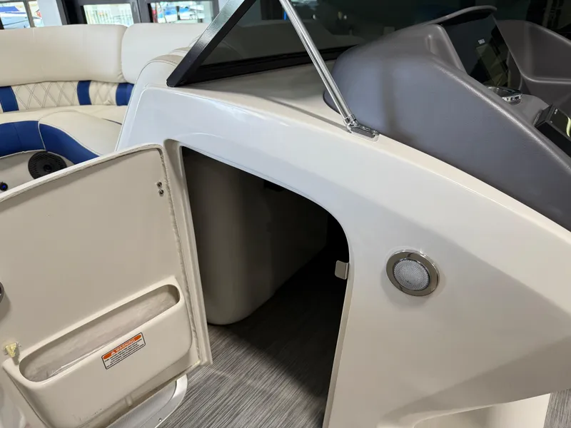 Slide: The Image of 2021 Bennington QX25 boat interior with open storage compartment and seating. - 39