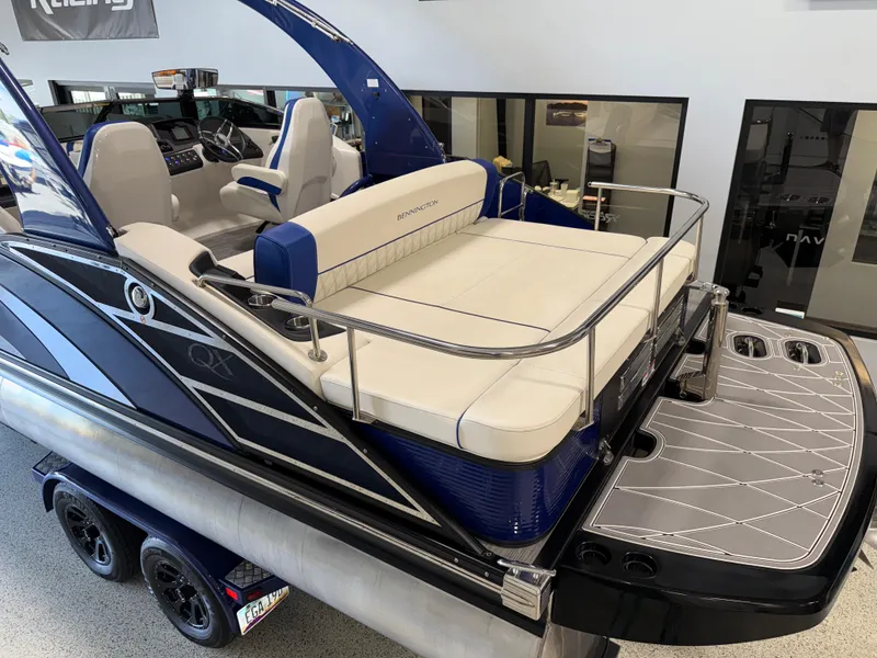 Slide: The Image of 2021 Bennington QX25 pontoon boat with luxurious seating and sleek design on display. - 4