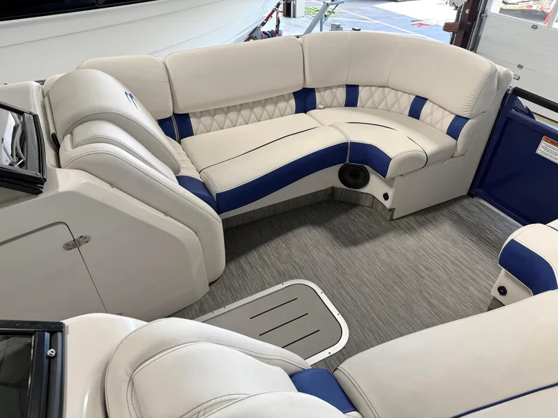 Slide: The Image of 2021 Bennington QX25 boat interior with white and blue cushioned seating. - 41