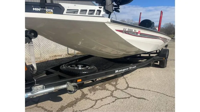 Slide: The Image of 2018 Ranger RT198P boat on trailer, parked on cracked pavement. - 5