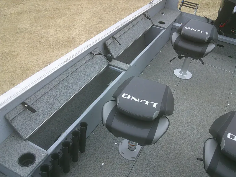 Slide: The Image of 2019 Lund 2000 Alaskan Tiller boat interior with seating and storage compartments. - 10