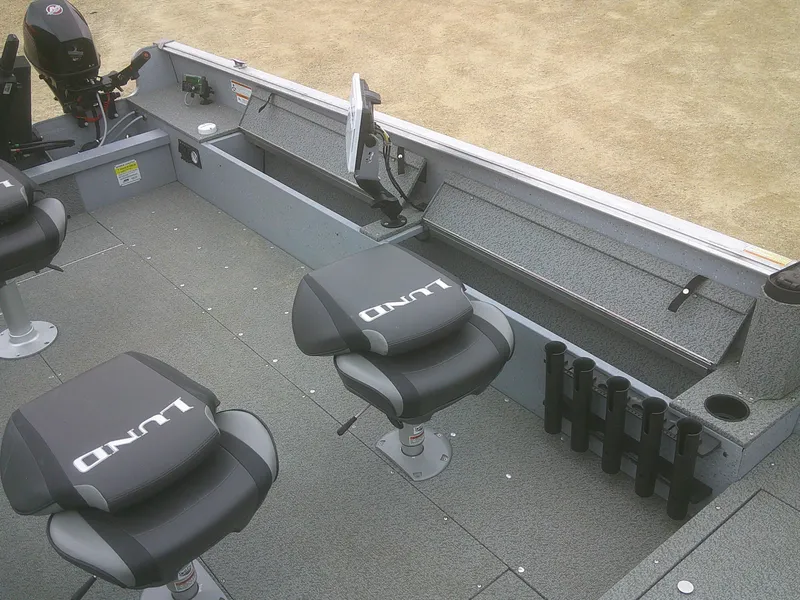 Slide: The Image of 2019 Lund 2000 Alaskan Tiller boat interior with seating and storage compartments. - 11