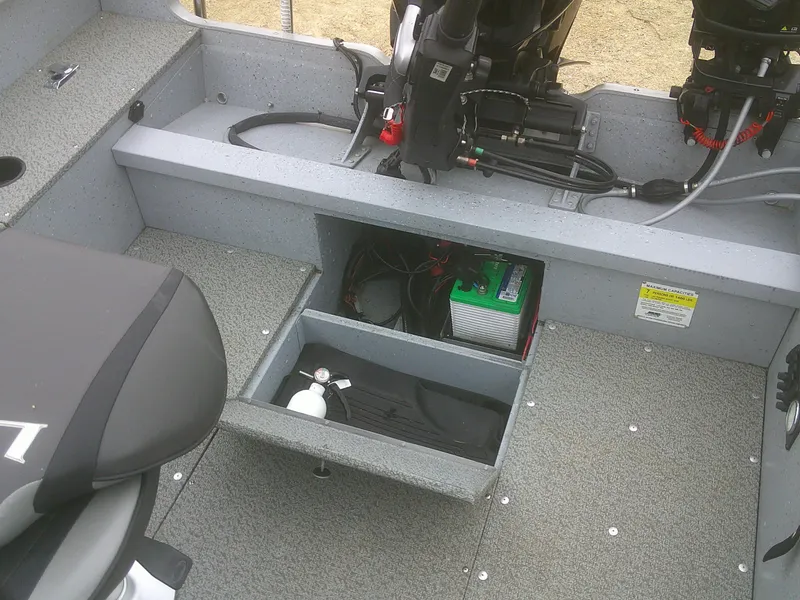 Slide: The Image of 2019 Lund 2000 Alaskan Tiller boat interior with storage compartment and equipment. - 13