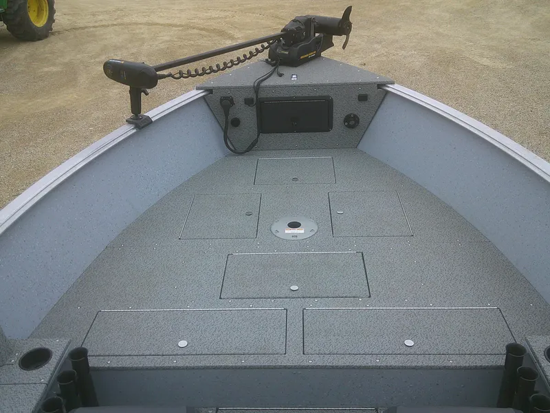 Slide: The Image of 2019 Lund 2000 Alaskan Tiller boat interior with storage compartments and trolling motor. - 4