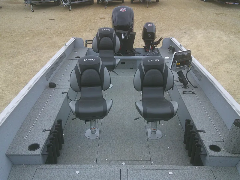 Slide: The Image of 2019 Lund 2000 Alaskan Tiller boat interior with seating and motor. - 9