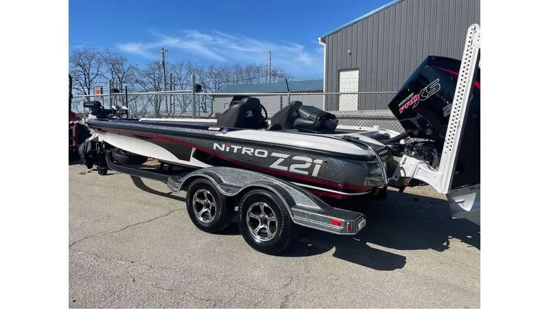 Slide: The Image of 2020 Nitro Z21 boat on trailer, parked outdoors near a building. - 10