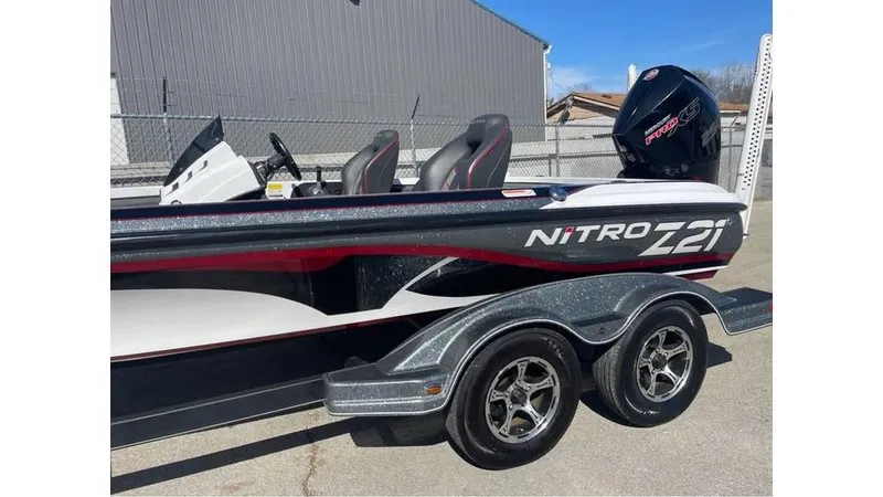 Slide: The Image of 2020 Nitro Z21 boat with dual seats and trailer, parked outdoors. - 3