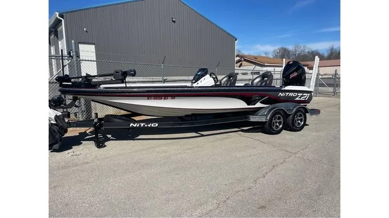 Slide: The Image of 2020 Nitro Z21 boat on trailer parked outdoors near a building. - 9