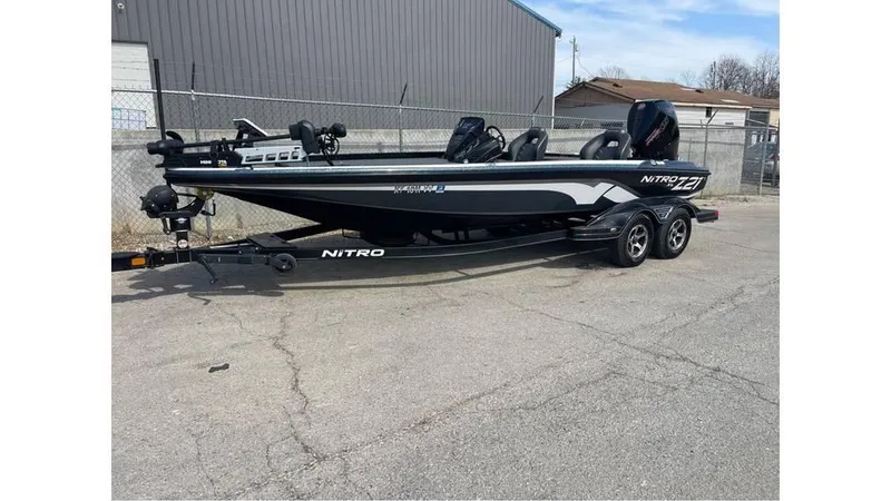 Slide: The Image of 2022 Nitro Z21 XL boat parked on a trailer in an industrial area. - 3