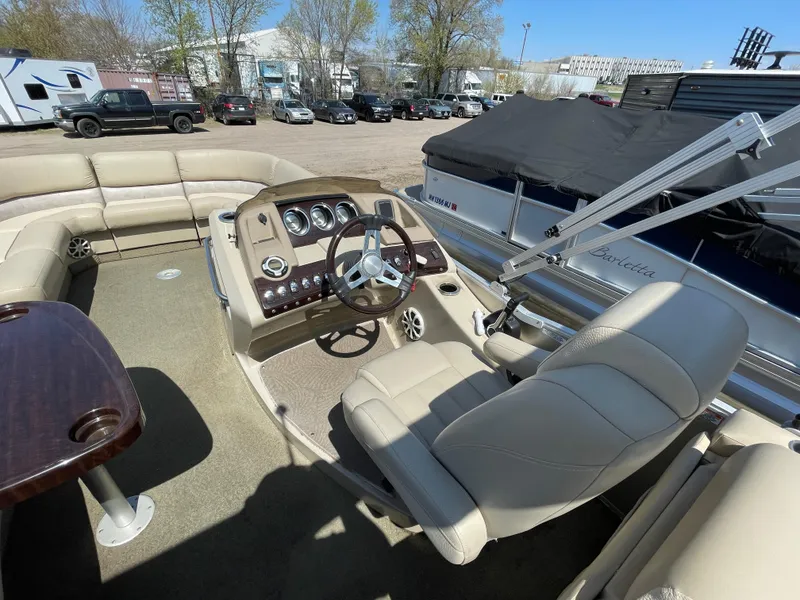 Slide: The Image of 2013 Bennington 2275 RCW pontoon boat interior with steering console and seating. - 13