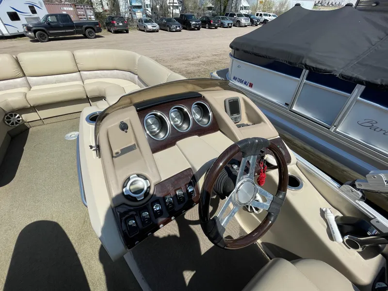 Slide: The Image of 2013 Bennington 2275 RCW boat interior with steering wheel and control panel. - 14