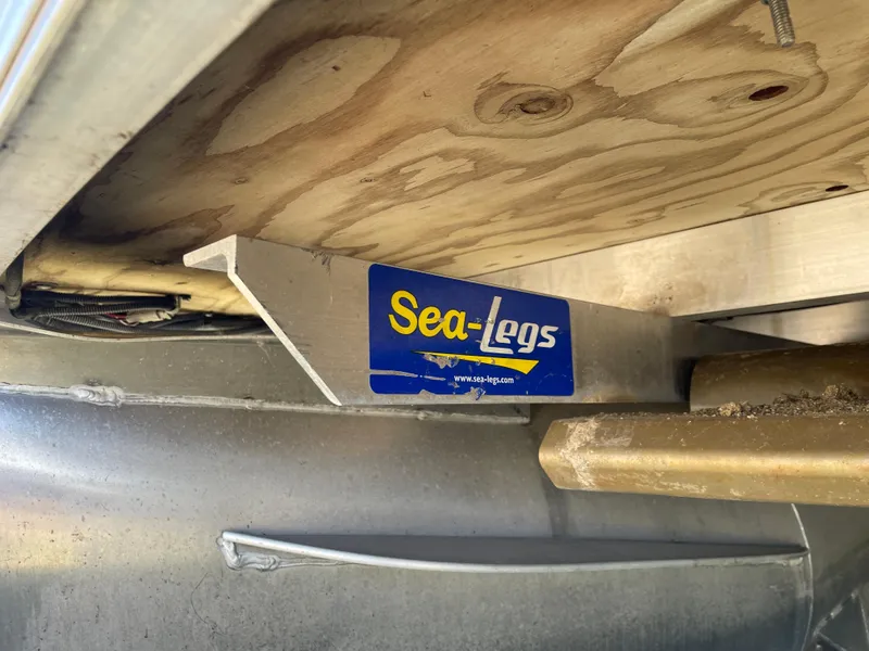 Slide: The Image of Sea-Legs mechanism on 2013 Bennington 2275 RCW pontoon boat, showcasing undercarriage details. - 17
