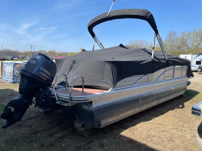 Slide: The Image of 2013 Bennington 2275 RCW pontoon boat with Yamaha outboard, covered and parked on grass. - 19