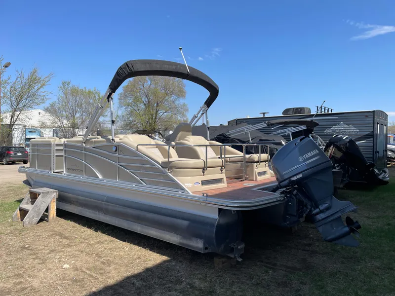 Slide: The Image of 2013 Bennington 2275 RCW pontoon boat with Yamaha outboard motor, parked outdoors. - 5