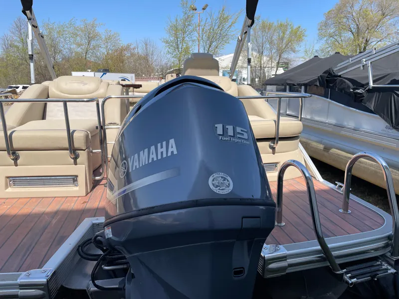 Slide: The Image of 2013 Bennington 2275 RCW pontoon boat with Yamaha 115 engine, beige seating, and wooden deck. - 6