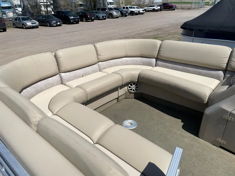 Slide: The Image of 2013 Bennington 2275 RCW pontoon boat with beige seating in a parking lot. - 8