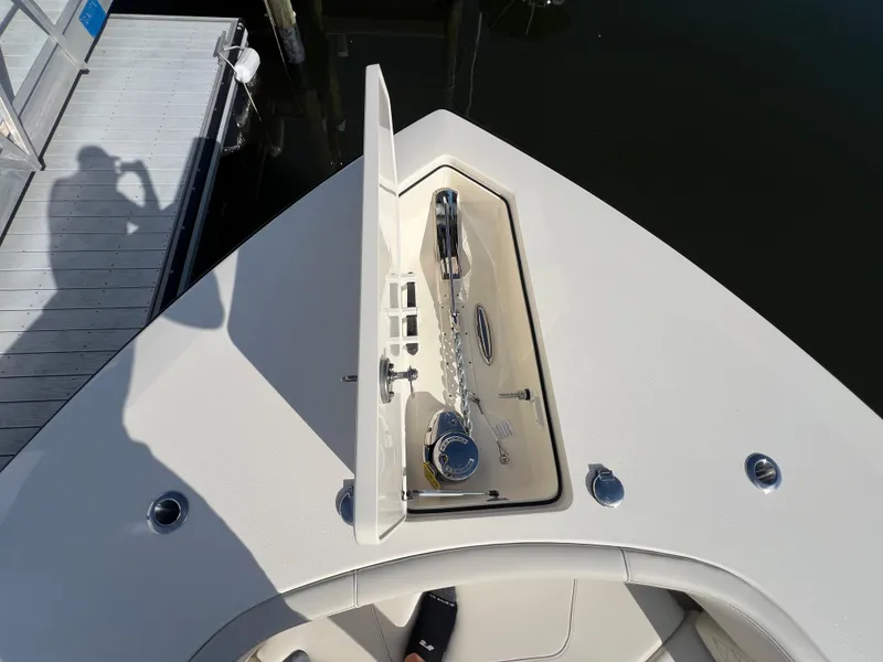 Slide: The Image of Bow of 2025 Scout 425 LXF with open anchor compartment, dockside view. - 10