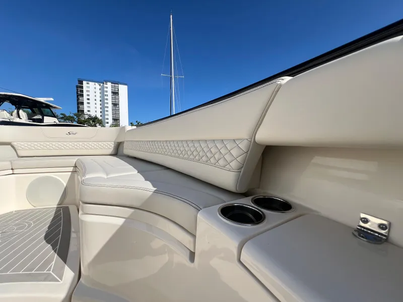 Slide: The Image of Luxurious interior of 2025 Scout 425 LXF boat with elegant seating and cup holders. - 14