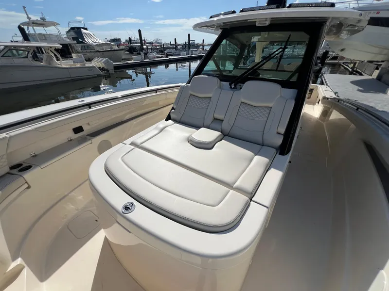 Slide: The Image of Luxurious 2025 Scout 425 LXF boat with plush seating at marina. - 16