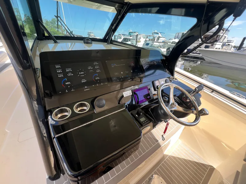 Slide: The Image of Helm of 2025 Scout 425 LXF boat with advanced navigation displays and controls. - 19