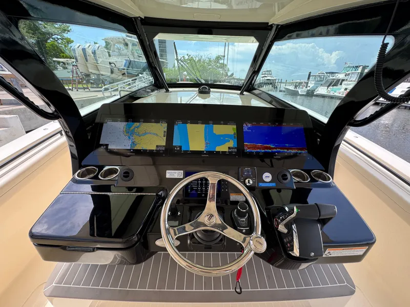 Slide: The Image of 2025 Scout 425 LXF boat dashboard with advanced navigation displays and controls. - 20