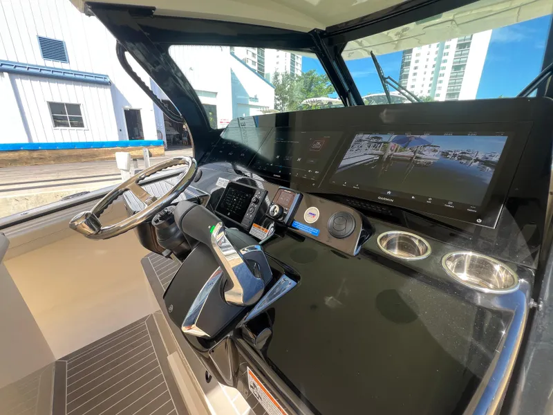 Slide: The Image of Helm of 2025 Scout 425 LXF boat with advanced navigation displays and controls. - 21