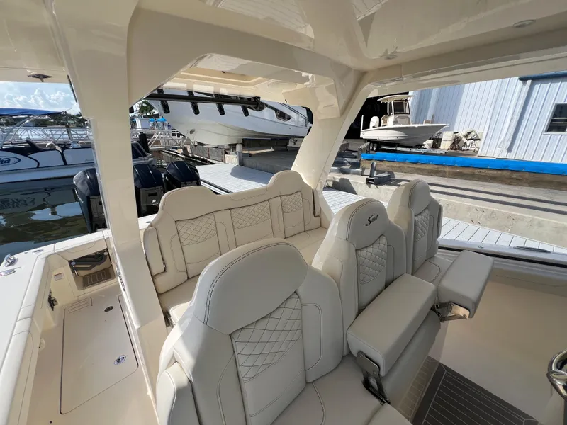 Slide: The Image of Luxurious seating on 2025 Scout 425 LXF boat at marina dock. - 24