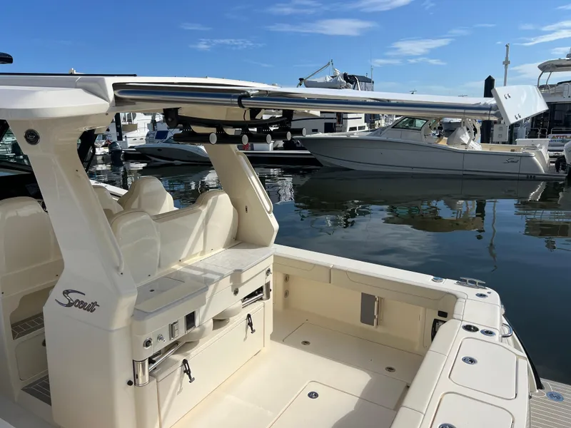 Slide: The Image of 2025 Scout 425 LXF boat docked at marina, showcasing sleek design and luxury features. - 27