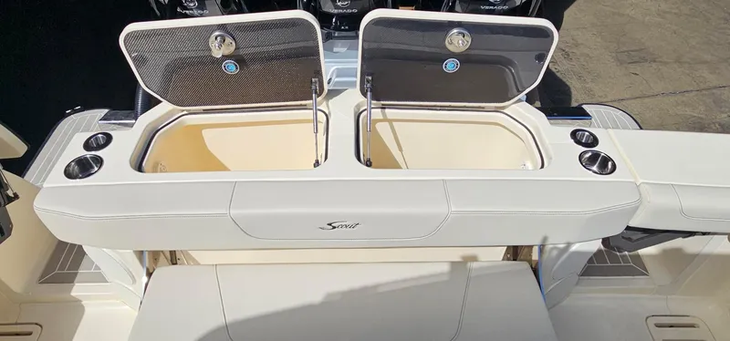 Slide: The Image of 2025 Scout 425 LXF boat with open storage compartments and cup holders. - 31
