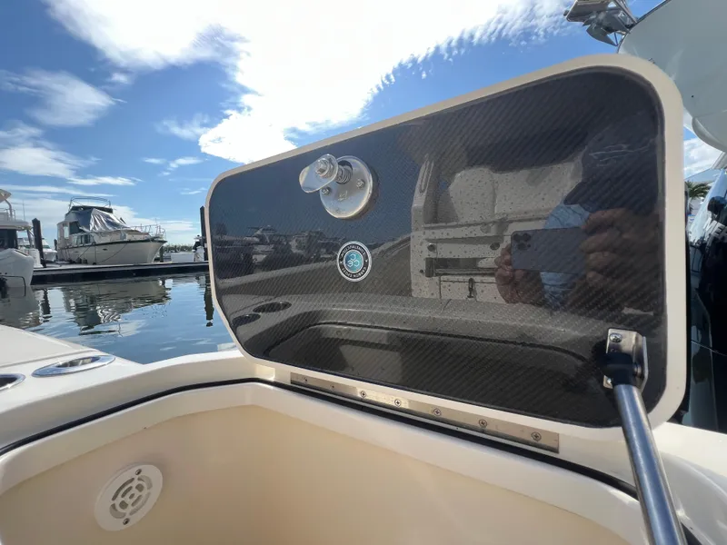 Slide: The Image of 2025 Scout 425 LXF boat detail with carbon fiber panel at marina. - 32