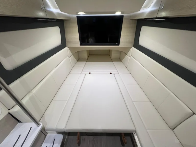 Slide: The Image of Luxurious interior of 2025 Scout 425 LXF boat with plush seating and TV. - 36