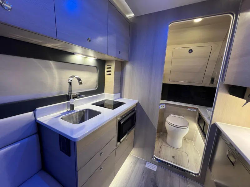 Slide: The Image of Luxurious interior of 2025 Scout 425 LXF boat featuring modern kitchen and bathroom. - 39