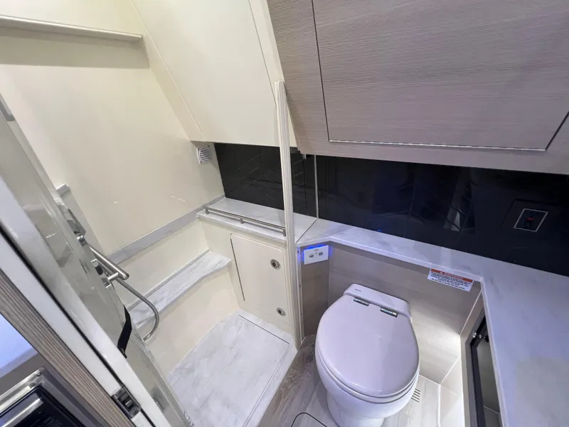 Slide: The Image of Luxurious bathroom interior of 2025 Scout 425 LXF boat, featuring modern fixtures and sleek design. - 42