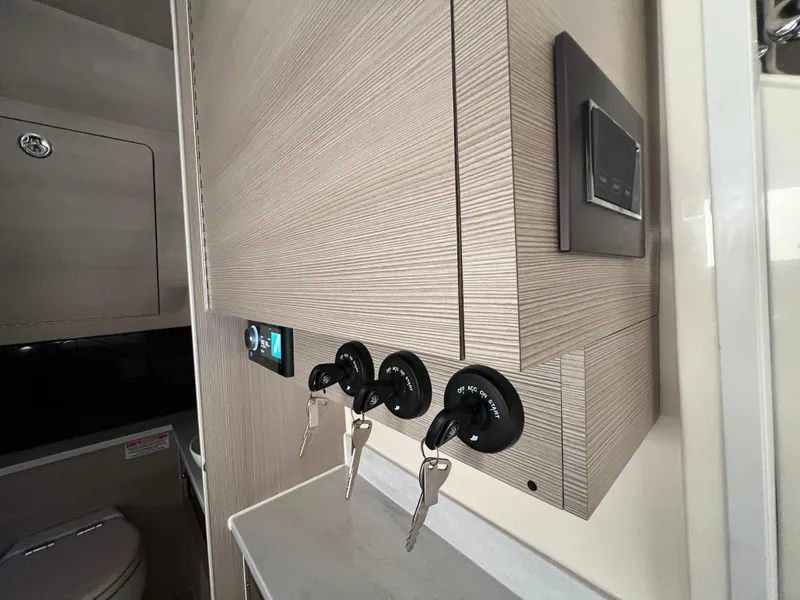 Slide: The Image of Interior of 2025 Scout 425 LXF boat with control panel and keys. - 43