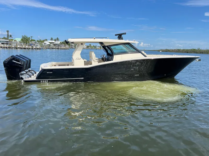 Slide: The Image of 2025 Scout 425 LXF boat on calm water, featuring sleek design and powerful Mercury engines. - 9