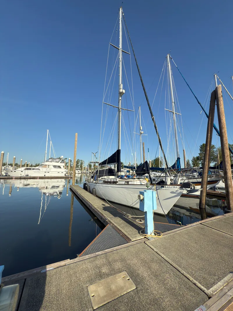 The Image of 1984 Spindrift Cutter sailboat docked at a marina under clear blue skies. - 1