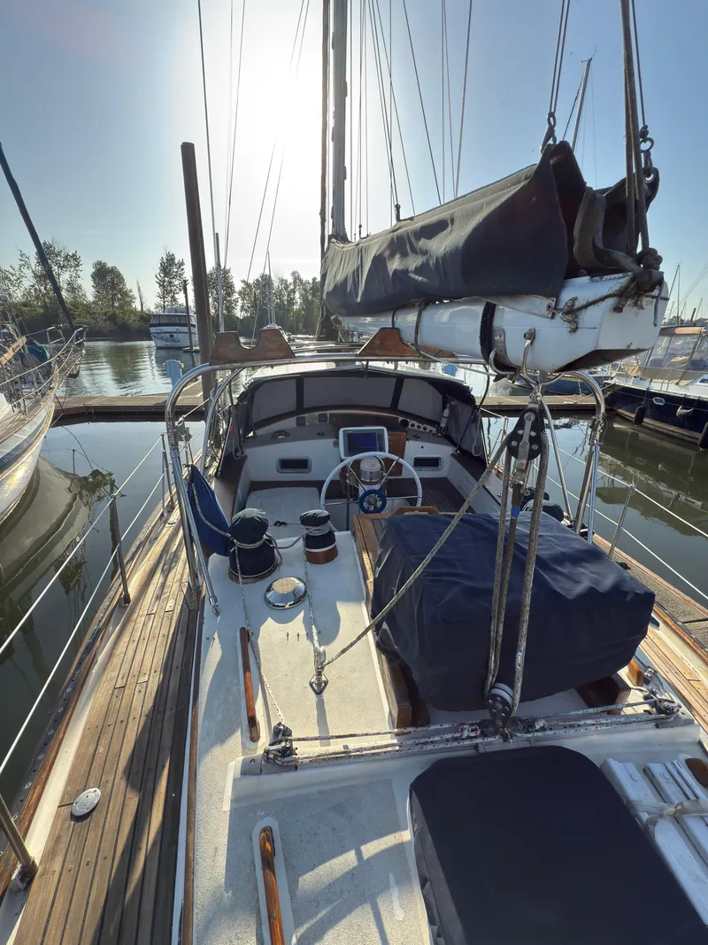 Slide: The Image of 1984 Spindrift Cutter sailboat docked at marina, sunny day, view of deck and cockpit. - 10