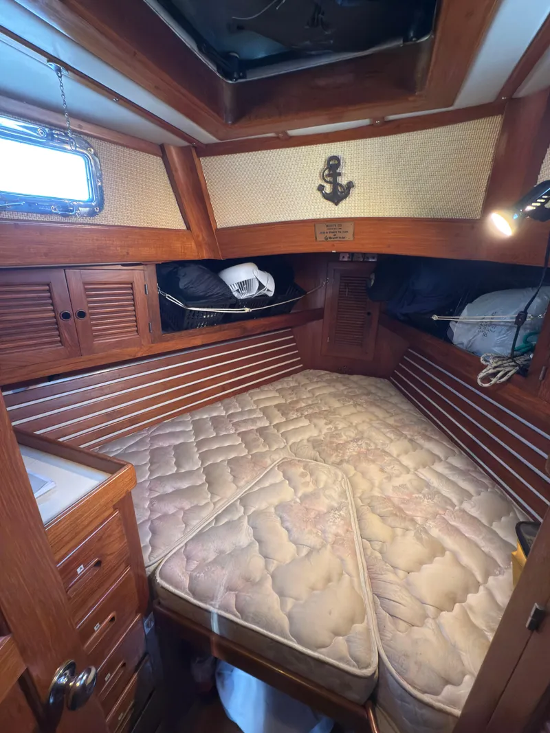 Slide: The Image of Cozy cabin interior of 1984 Spindrift Cutter sailboat with wooden accents and a comfortable bed. - 22