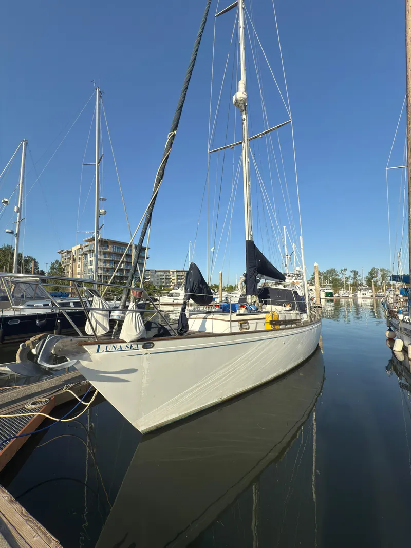 Slide: The Image of 1984 Spindrift Cutter sailboat docked in a marina under clear blue skies. - 3
