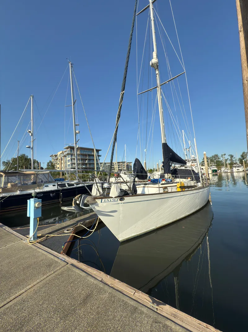 Slide: The Image of 1984 Spindrift Cutter sailboat docked in a marina under clear blue skies. - 4