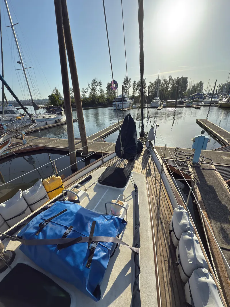 Slide: The Image of 1984 Spindrift Cutter sailboat docked at a marina under clear skies. - 6