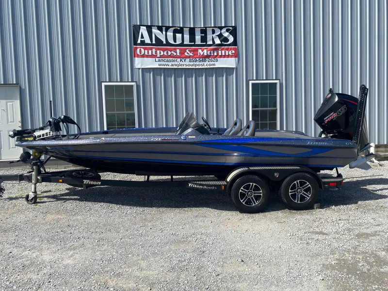 Slide: The Image of 2019 Triton 20 TRX Patriot boat parked outside Anglers Outpost & Marine. - 1